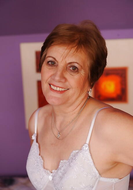 Stunning grandma Piros in sexy underwear bares tiny tits and hairy pussy 
